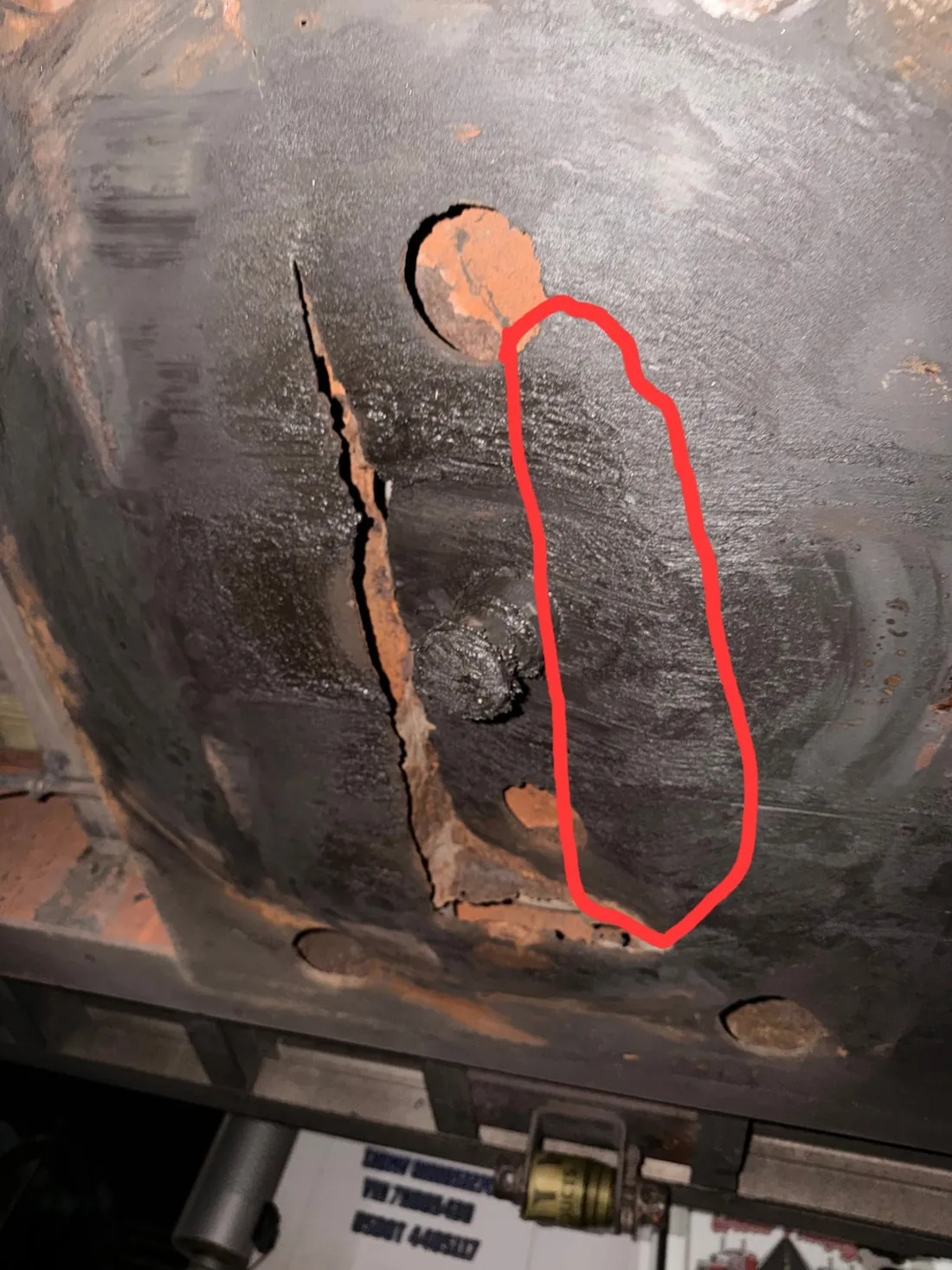 Damaged metal section before repair with severe crack and rust